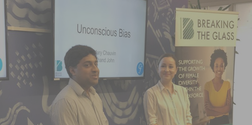 Photo of two people with a slide entitled Unconscious Bias in the background